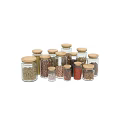 Glass Spice Jars With Wooden Lids Holding Various Spices For Organized Kitchen