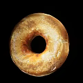 Appetizing Golden Brown Freshly Baked Bagel With Hole And Crusty Surface On Black Background
