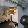 Modern Gold Layered Shade Floor Lamp In Cozy Living Room With Sofa And Plant