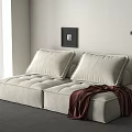 Beige Upholstered Two Seater Sofa With Cushions And Blanket In Modern Living Room