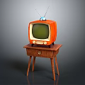 Vintage Orange Television With Antenna And Green Screen On Wooden Table