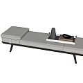 Modern Ottoman With Gray Upholstery Black Metal Legs And Tray With Books And Decorative Items