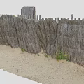 Wooden Fence Made Of Poles And Wire On Sandy Ground
