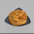 Delicious Spiral Bread with Golden Crust on Dark Square Plate Topped with Nuts