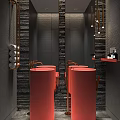 Modern Public Toilet Interior With Red Washbasins Black Tiled Walls And Brass Fixtures