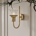 Elegant Brass Wall Lamp with Fluted Glass Shade Mounted on White Panel Wall