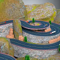 Winding Mountainous Terrain With Multi Layered Roads Stone Walls Rocky Cliffs And Green Trees