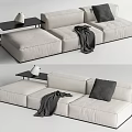 Beige Sectional Sofa Featuring Gray Pillow Blanket and Black Side Table with White Vase