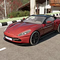 Sleek Red Sports Car Exterior Design Parked On Scenic Road With Trees And Buildings