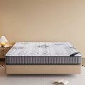 Comfortable Mattress With Patterned Surface On Bed Base Near Nightstand And Table Lamp