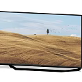 Modern TV Screen Displaying Golden Wheat Field With Single Tree Flying Birds And Blue Sky