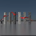 Art Installation with Gray Black Columns Red Gray Ribbons Under Blue Sky Over Water Surface