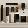 Assorted Headphone Speaker Types Including Floor Standing Bookshelf Compact Black Silver on White Shelf
