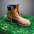 Brown Leather Work Boot With Dark Collar And Lace Up Design On Green Grass Platform