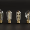 Four Transparent Glass Light Bulbs With Golden Base And Visible Filament On Dark Background
