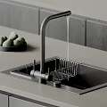 Stainless Steel Kitchen Sink With Black Faucet Running Water And Drying Rack On Gray Countertop