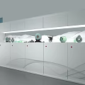 Modern White Display Cabinet Shelving With Green Ceramic Decorative Items And Lighting