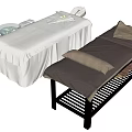 Comfortable Massage Tables with White Sheets Tray Bowl Dark Surface Brown Pillows and Black Frame