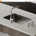 Modern Black Kitchen Sink With Brushed Nickel Faucet On Light Gray Countertop And Glass Tumblers