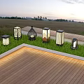 Outdoor Lights With Various Designs On Grass Near Wooden Deck At Twilight