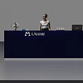 Exhibition Reception Desk With Dark Blue Design White Flowers Laptop And Female Staff