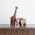 Geometric Wooden Animal Dolls Giraffe and Elephant with Simple Design on Table White Wall Background