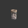 White Nuts Stored in Glass Jar with Wooden Lid on Dark Background