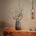 Gray Vase With White Flowered Branches On Wooden Table With Landscape Background And Hanging Lamp