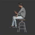 Man In Gray Shirt And Light Blue Jeans Sitting On Bar Stool Holding Smartphone
