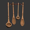 Four Decorative Wooden Spoons Hanging On Wall Mounted Rack For Kitchen Utensil Storage And