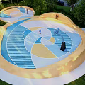 Unique Outdoor Basketball Court With Colorful Geometric Floor Design Surrounded by Greenery