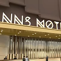 Modern Motel Facade Design With Brown Awning And Inn Motel Logo Sign