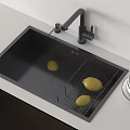 Black Kitchen Sink With Drying Rack Yellow Fruits And Faucet On Light Countertop