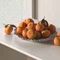 Fresh Ripe Oranges on a Plate on White Table with Green Leaves Near Window Blinds