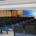 Modern Conference Room Interior Design With Blue Chairs Podium And Large Screen