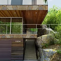Rustic Detached Villa With Wooden Roof Stone Walls Large Windows And Rocky Surroundings