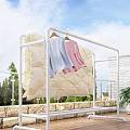 White Clothes Drying Rack With Quilt And Light Blue Pink Clothes On Balcony