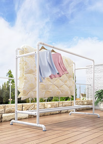 White Clothes Drying Rack With Quilt And Light Blue Pink Clothes On Balcony 3d model
