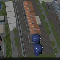 Aerial View Of Industrial Factory With Large Buildings Blue Storage Tanks And Greenery