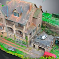 Traditional Stone Building With Sloped Roof Balcony Courtyard Table Chairs Green Vegetation