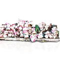Pile Of Broken Ceramic Fragments With Pink And White Patterns And Small Green Object