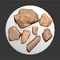 Brown Wooden Stone Pieces of Various Shapes Displayed on White Plate