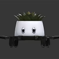 White Planter With Eye Patterns And Spider Like Legs Holding Succulent Plant
