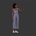 A woman in blue checkered jumpsuit pointing against gray background with white shoes