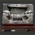 Ancient Stone Carved Capital With Decorative Animal Heads On Red Base