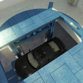 Black Car Parked On Blue Grid Pattern Floor In Indoor Area With Overhead Lighting
