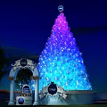 Giant Colorful Light Up Tree Decoration With Archway And Night Sky Background