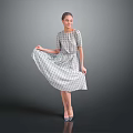 Woman Lifting Patterned Dress Standing With High Heels On Gray Background