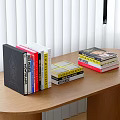 Books On Wooden Desk With Stacked And Upright Spines And Colorful Cover Details