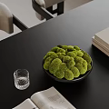 Modern Decorative Ornament Arrangement With Green Moss In Black Bowl And Glass Cup On Tabletop